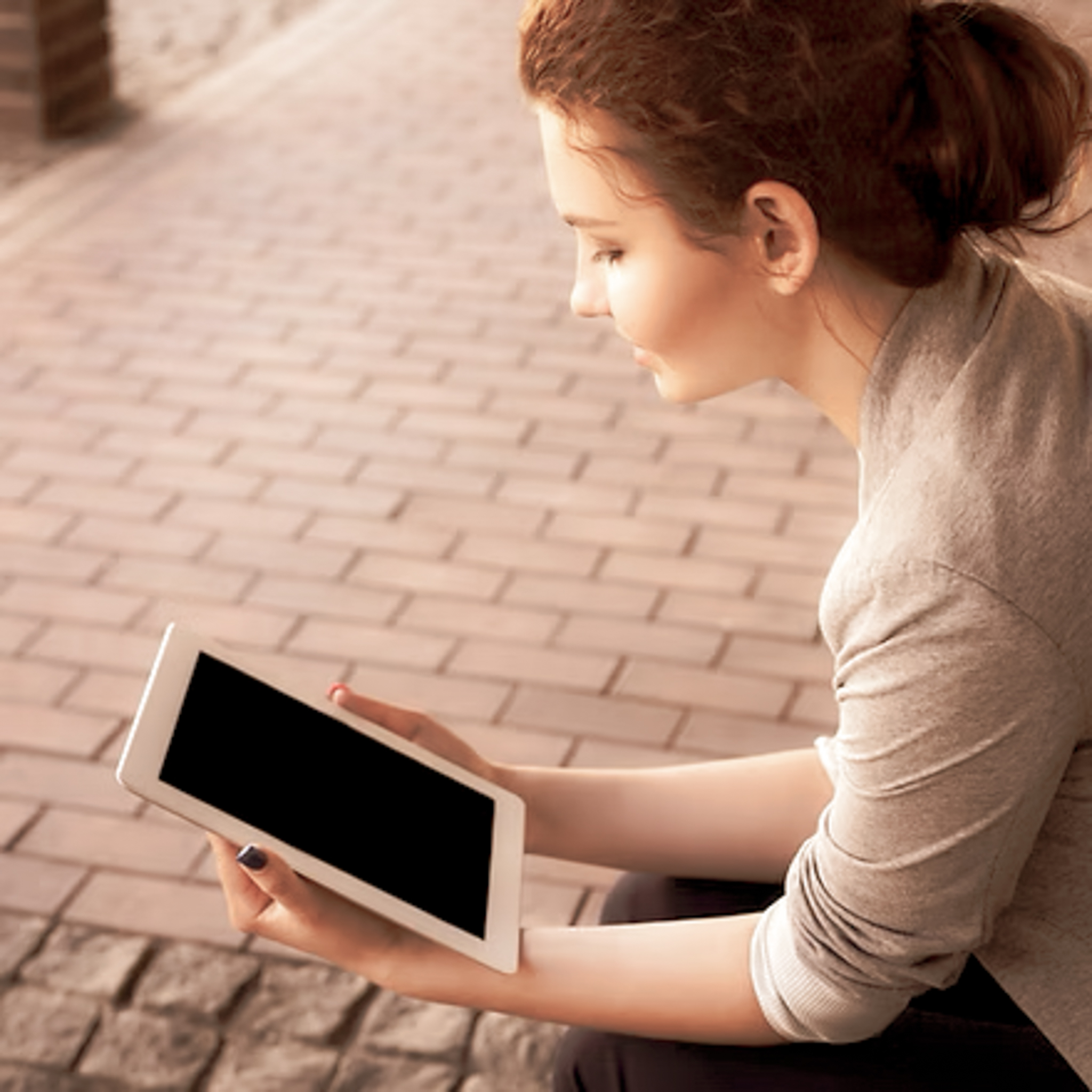 Patient using tablet for telehealth dermatology consultation